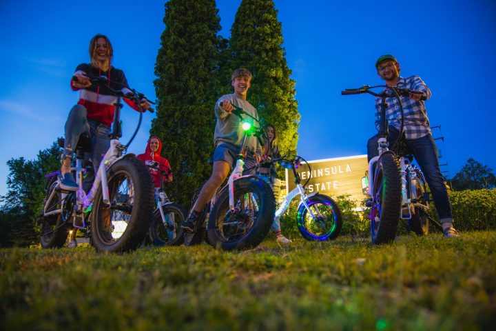 a group of people riding on the back of a motorcycle